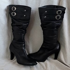Leather high heel slouch boots with silver buckles.